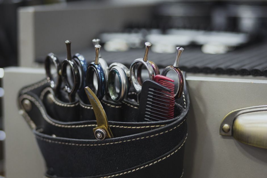 Hairdresser scissors close up during a cut